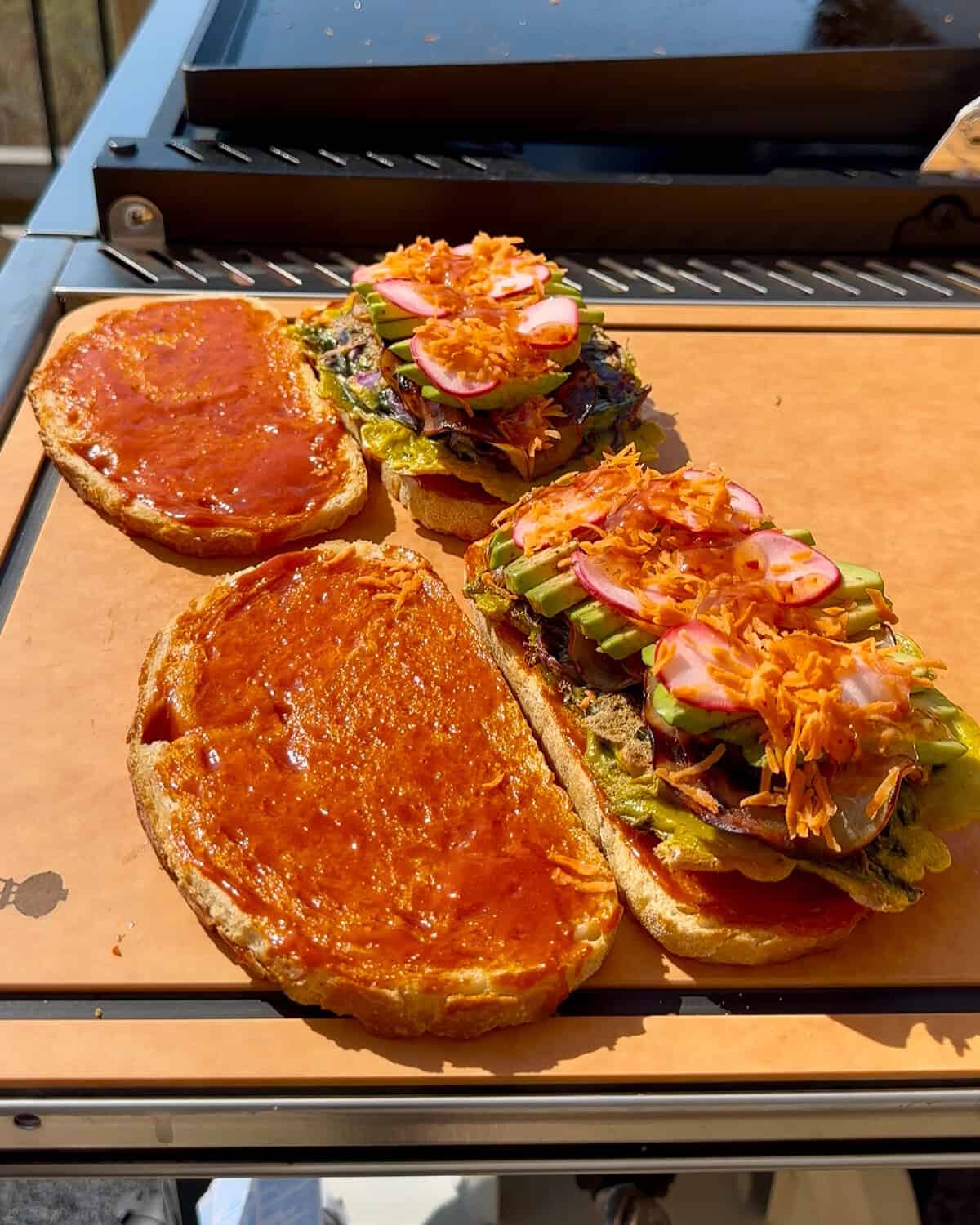 Assemble the Korean Street Toast - add the radishes, carrots and extra sauce