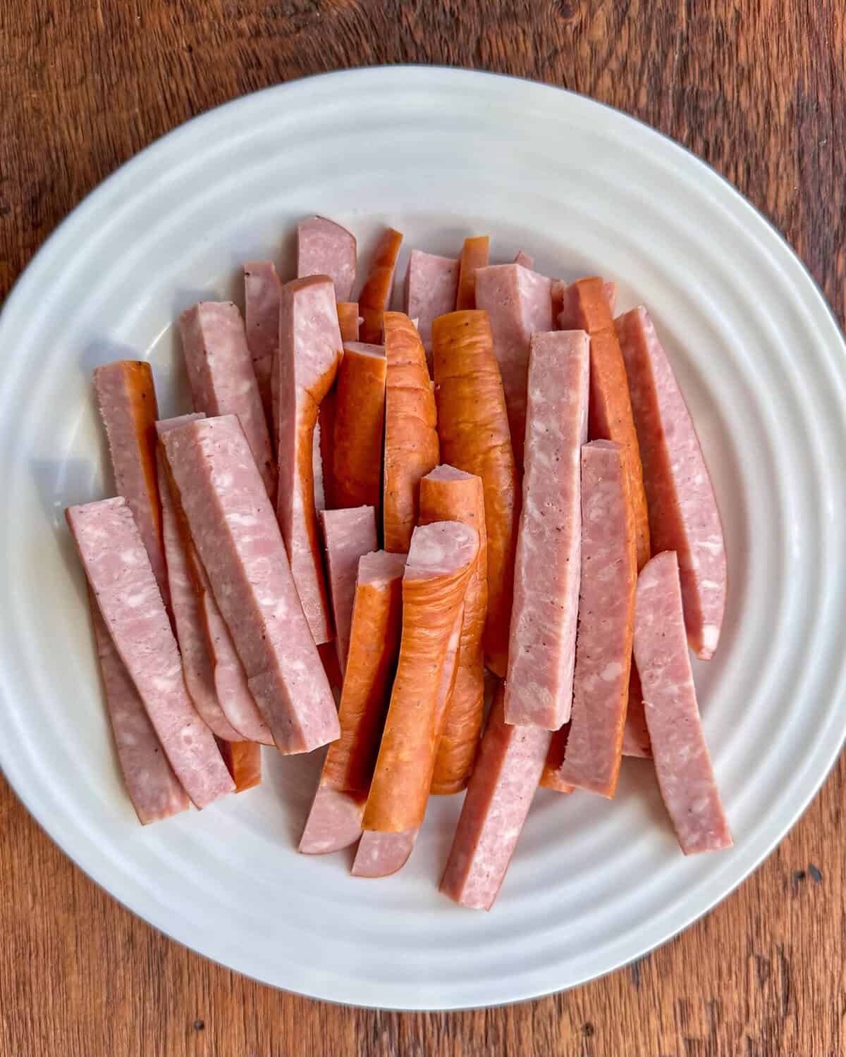 Cut the kielbasa into strips for air frying.