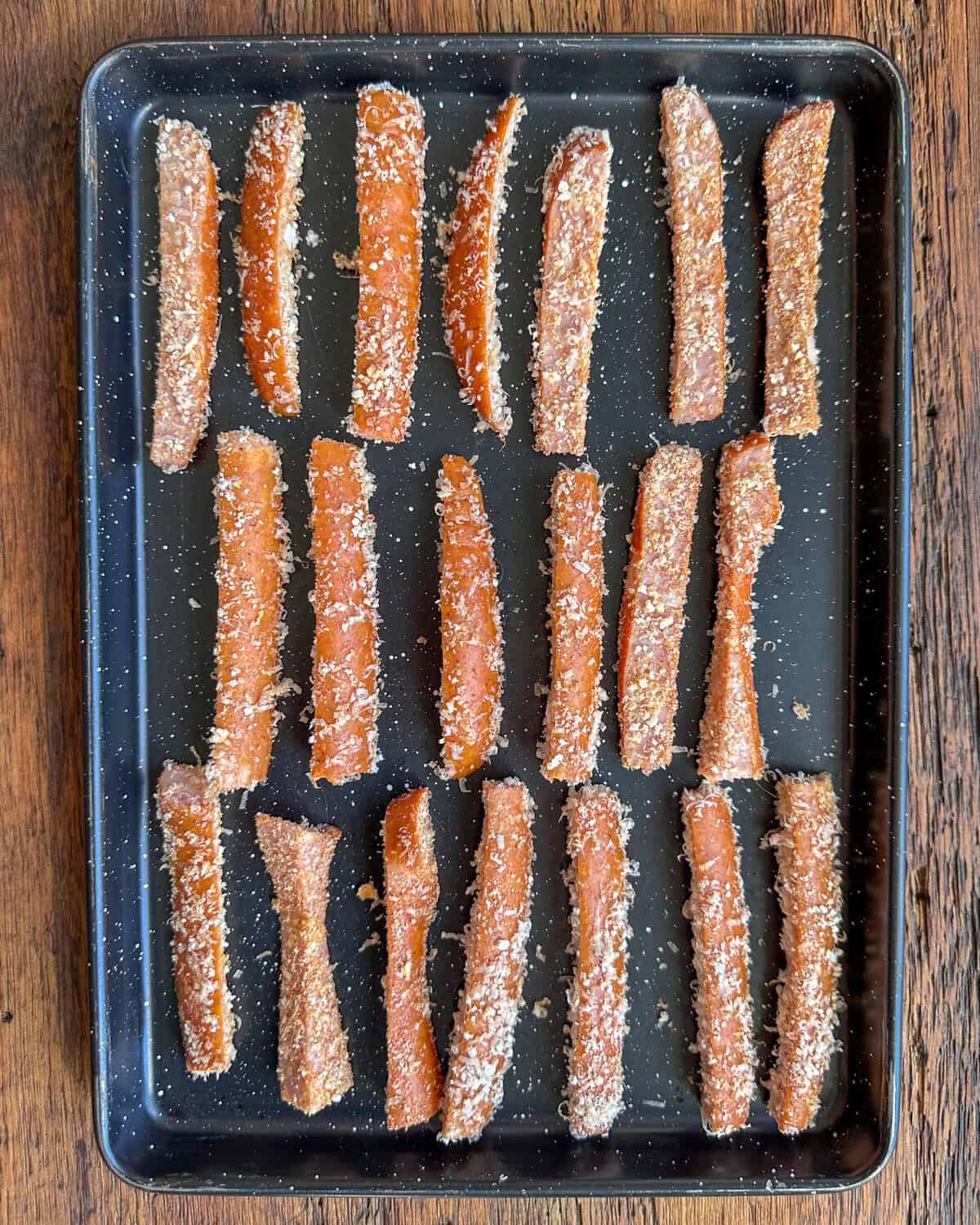 A tray of coated kolbassa fries, ready for the air fryer.