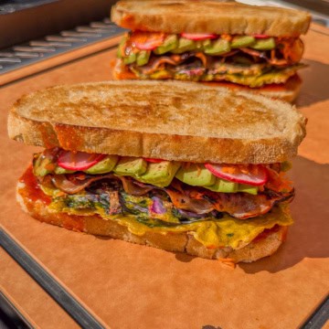 Two Korean Street Toast breakfast sandwiches with colourful ingredients.