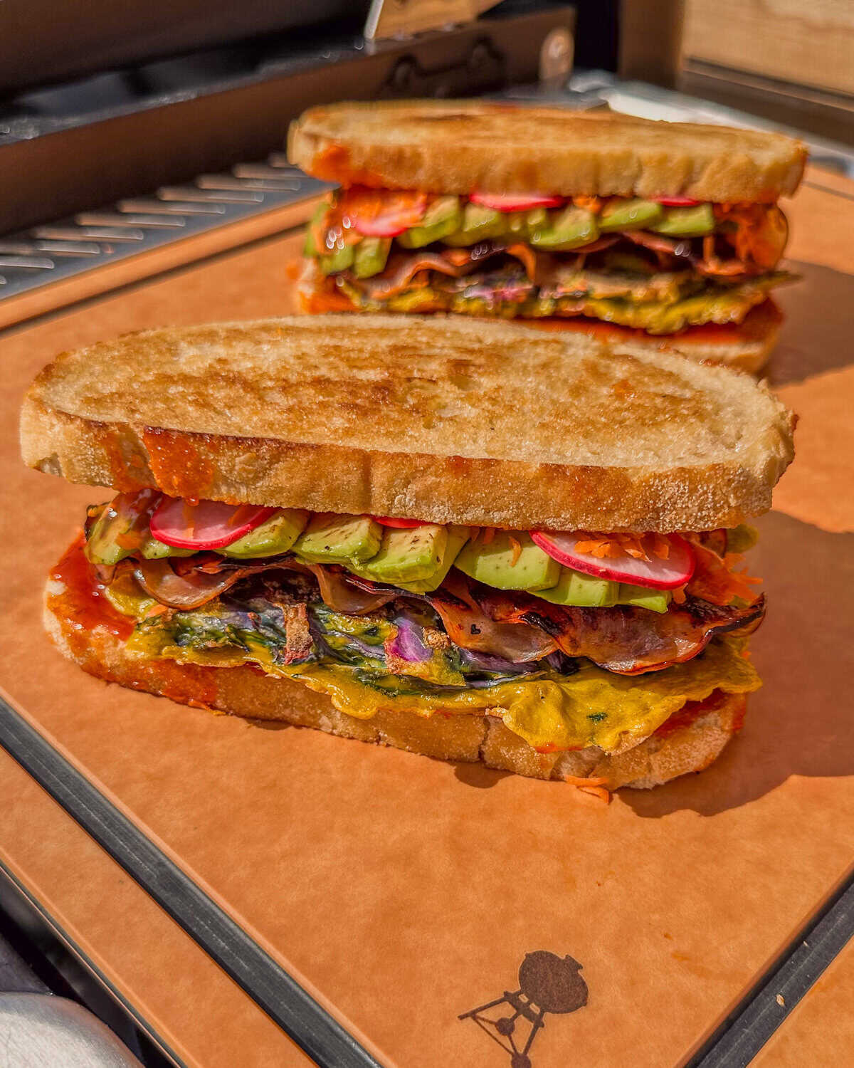 Two Korean Street Toast breakfast sandwiches with colourful ingredients.