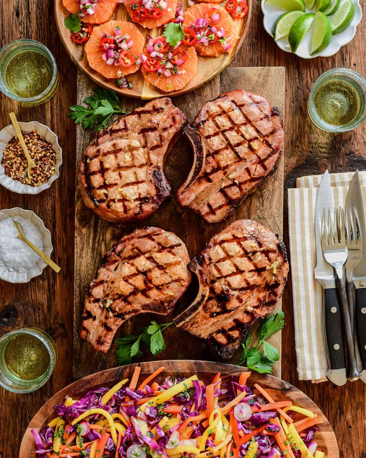 Four reverse seared pork chops served with an orange salsa and a smoky mojo red cabbage slaw.