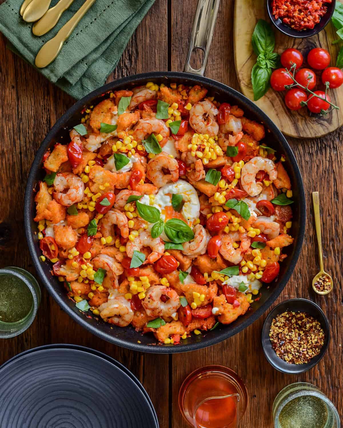 A spicy shrimp panzanella skillet with torn basil and burrata.