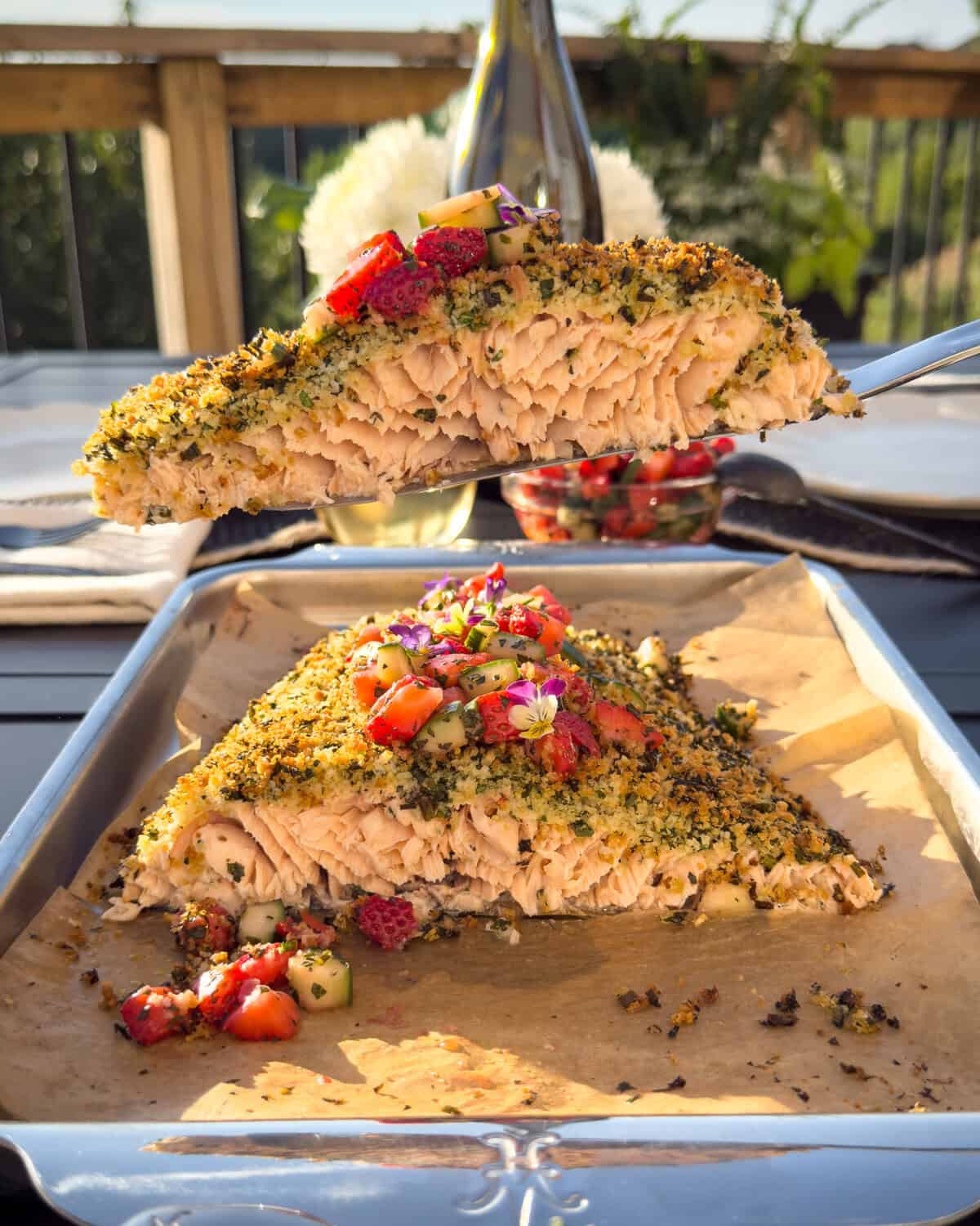 A cut-out piece of an herb-crusted salmon with a strawberry salsa.