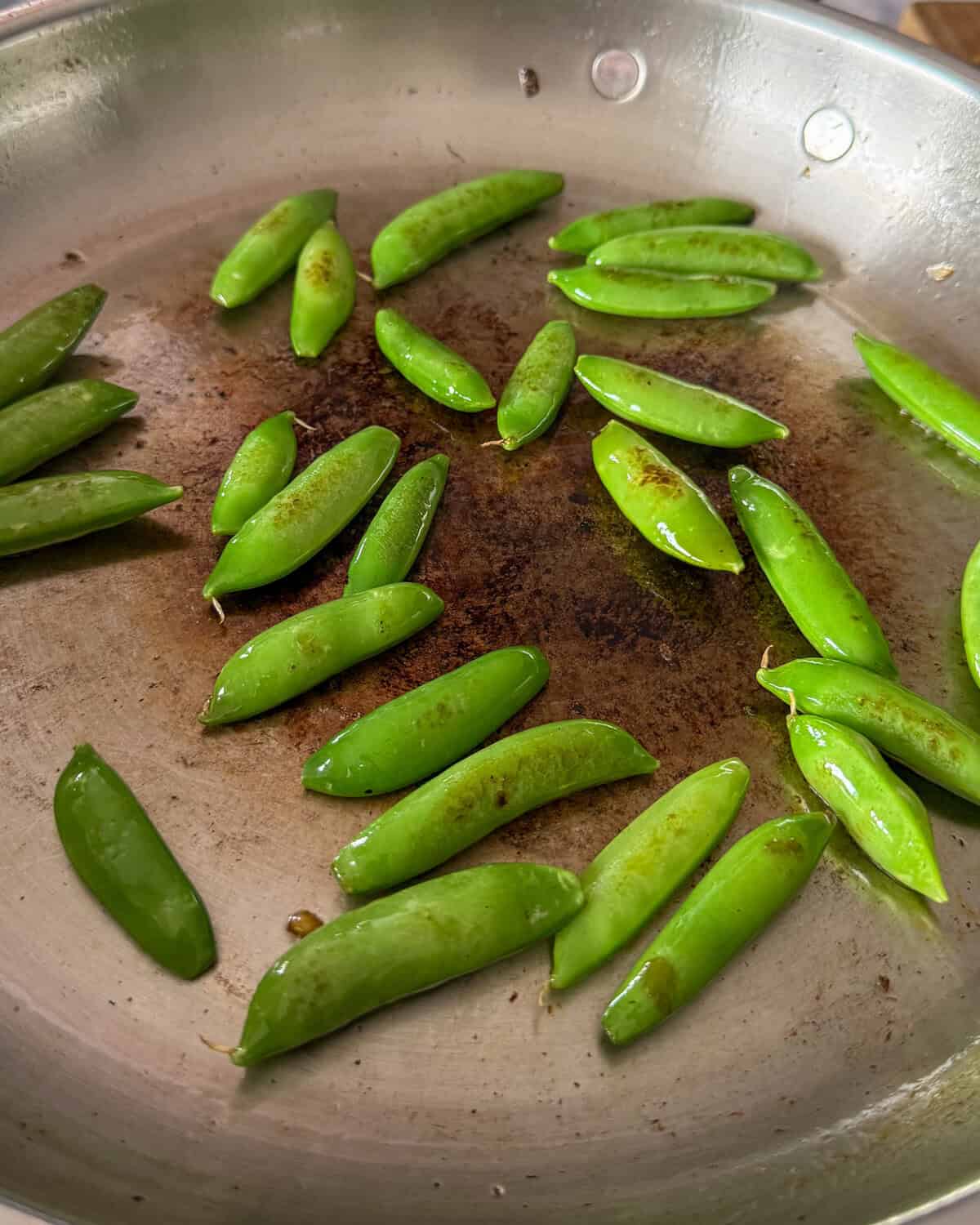 Blistered snap peas for a charred corn salad.