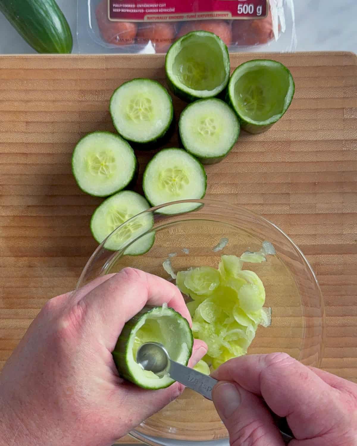 Hollow out the cucumber cups, leaving a base.