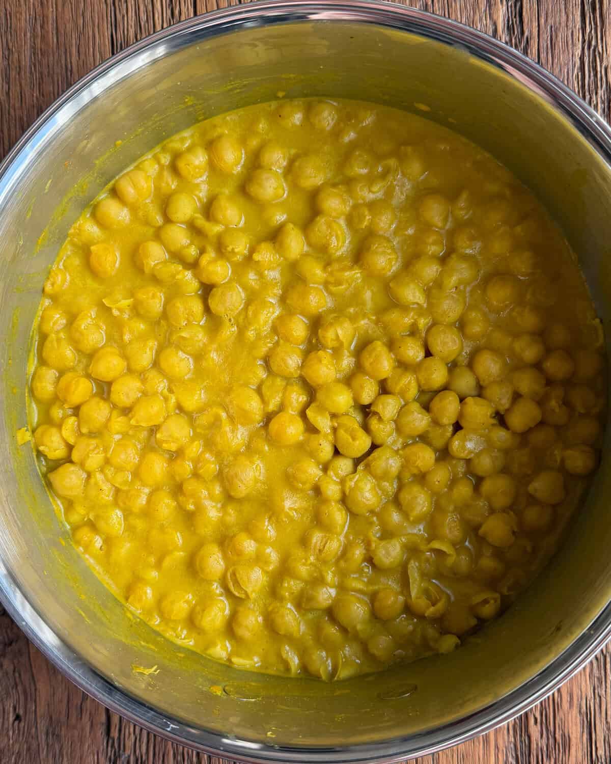 A pot of simmered chickpeas in coconut milk.