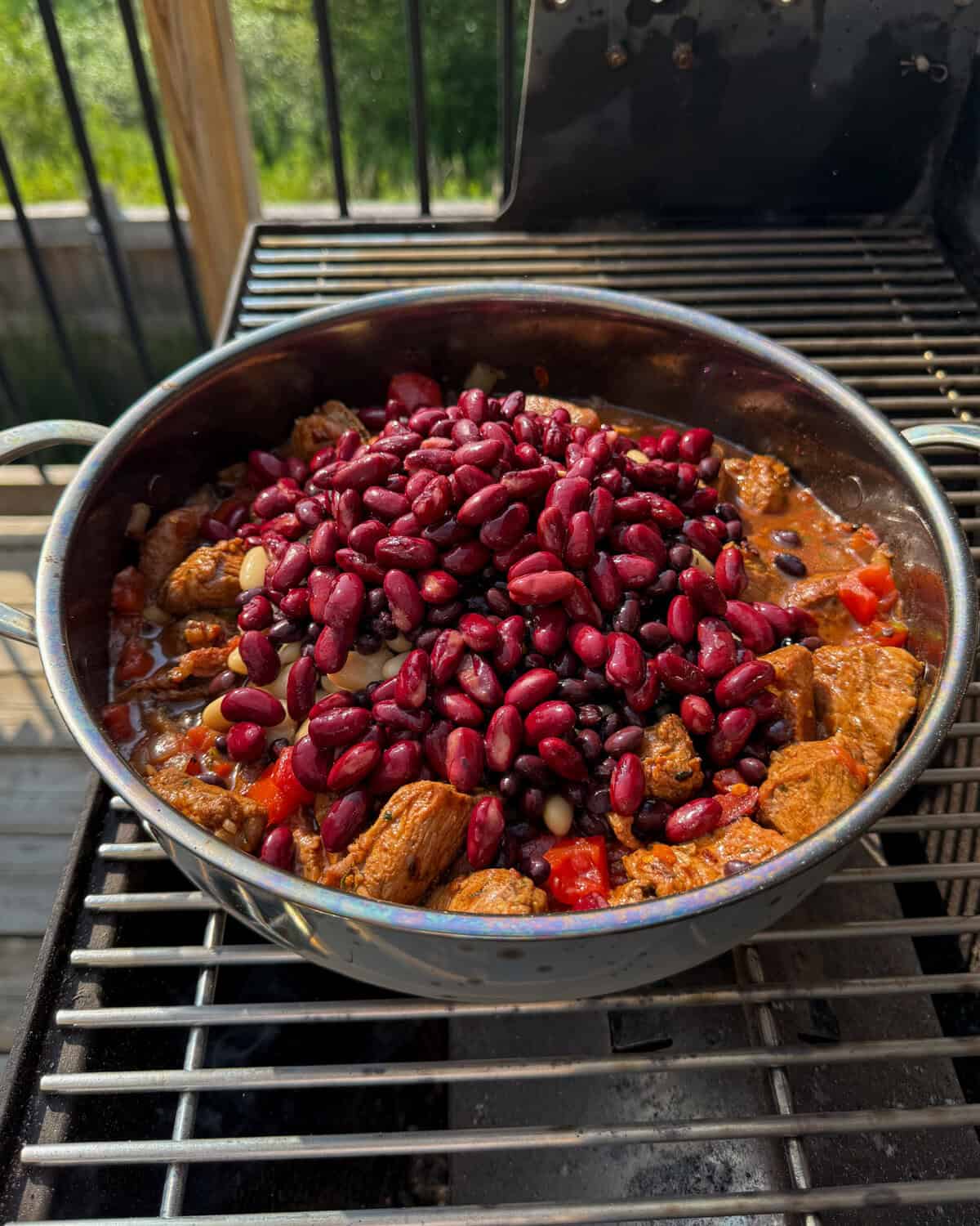 Add the pork and beans to the Caribbean baked beans Dutch oven.