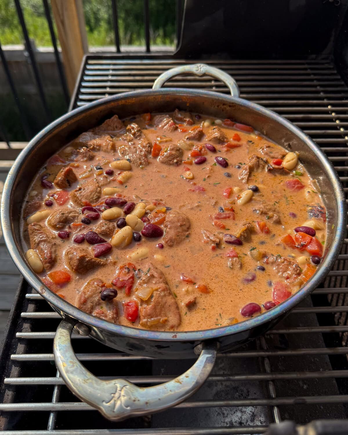 Add the coconut milk to the Caribbean baked beans Dutch oven.
