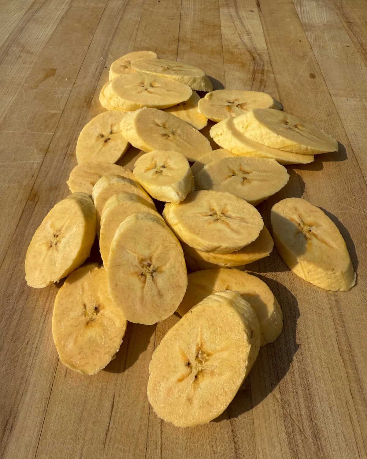 Diagonal plantain slices for a Caribbean baked beans recipe.