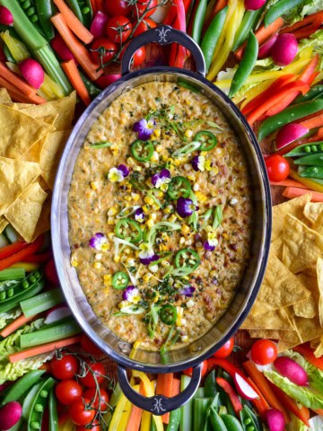 A Charred Corn, Poblano and Jalapeño Dip served with colourful veggies and chips.