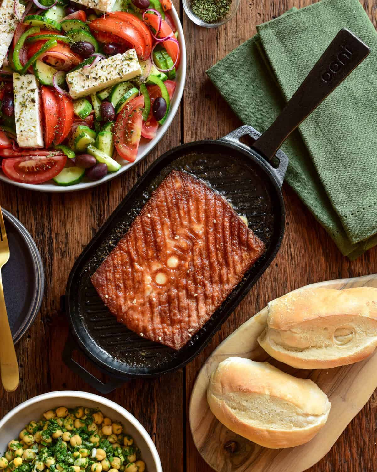 Saganaki cheese on an Ooni cast-iron and served with a Greek village salad and a chickpea salad.
