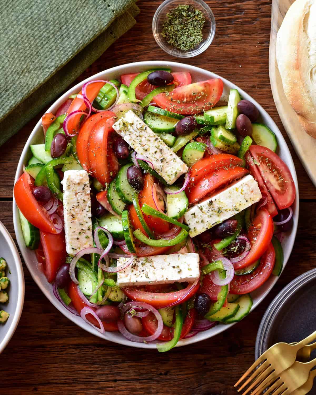 A Greek Village Salad (Horiatiki Salata) with four pieces of feta on top.