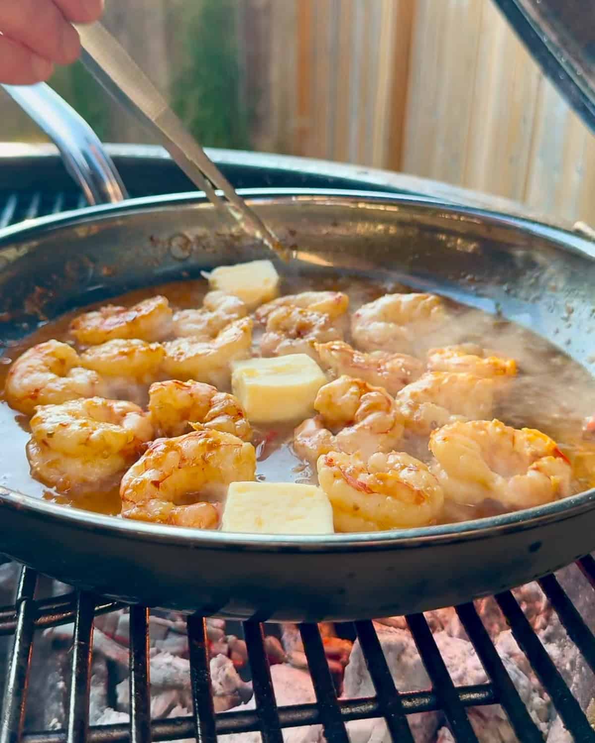 Add butter to the shrimp and sauce.