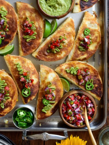 Cheesy Chorizo Quesadillas with Corn and Manchego. Served with guacamole, pico de gallo and sliced jalapenos.