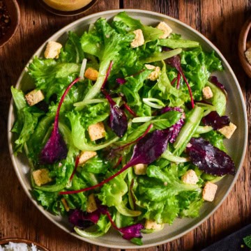 A simple green salad with croutons and a shallot vinaigrette.