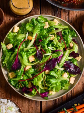 A simple green salad with croutons and a shallot vinaigrette.