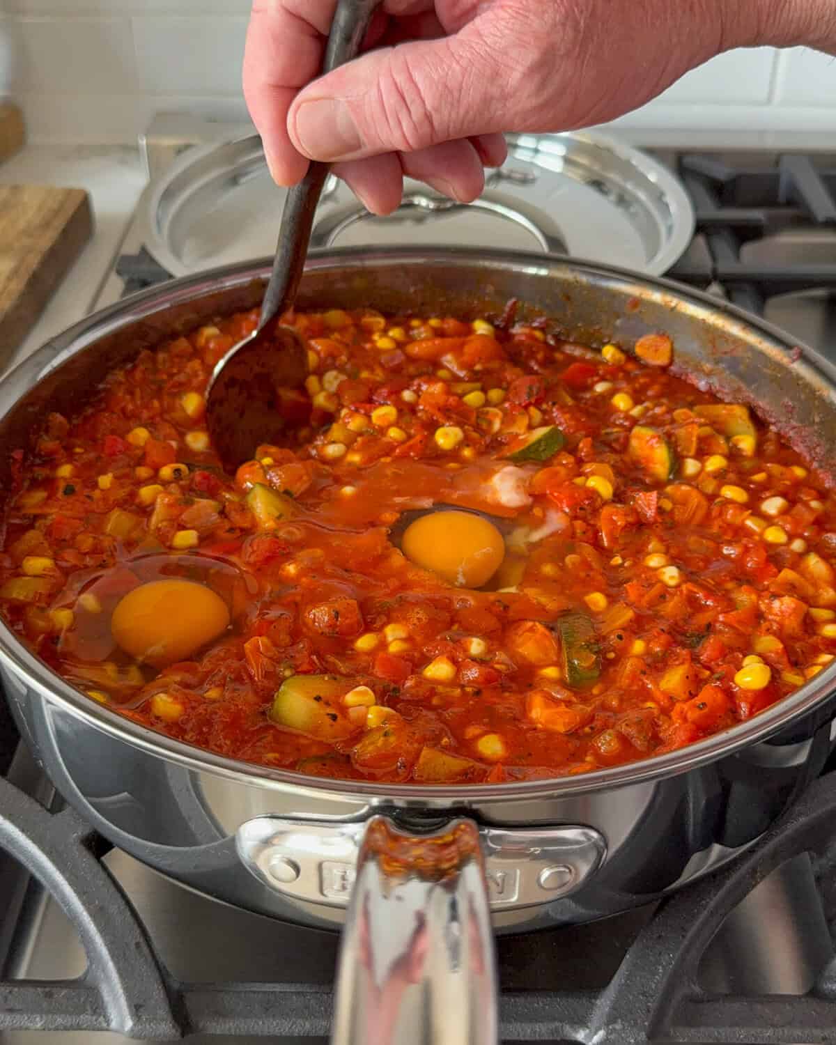 Make a well in the pan with a spoon for the eggs. 