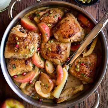 A pot of Apple Cider Glazed Chicken with Apples and Fennel.