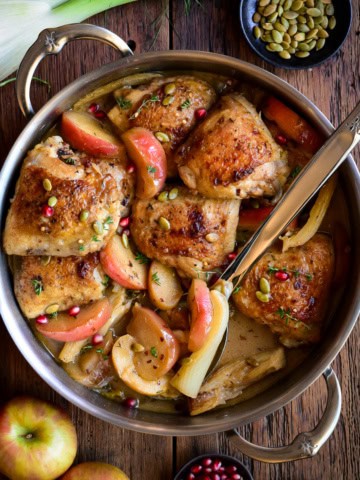 A pot of Apple Cider Glazed Chicken with Apples and Fennel.
