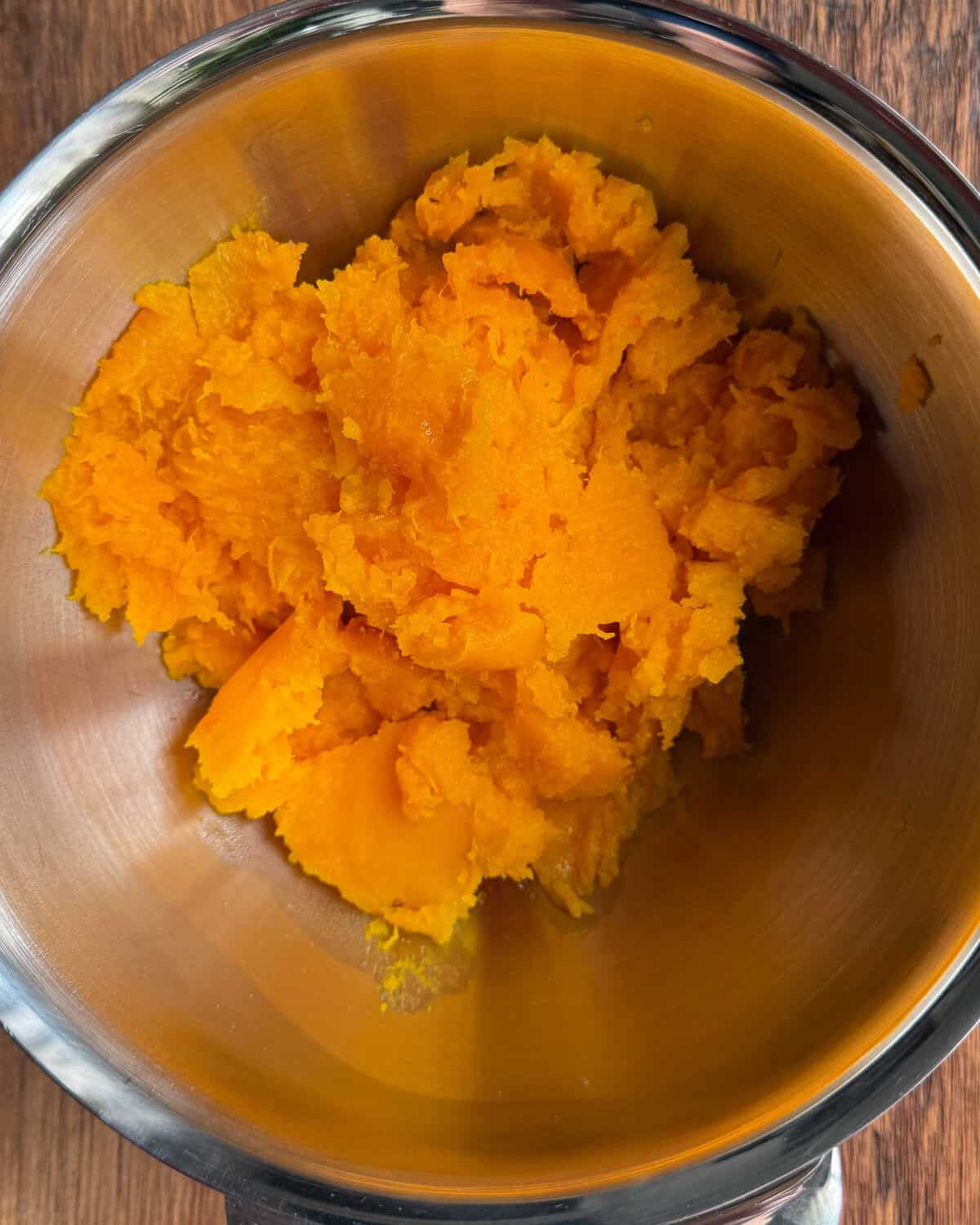 Scoop out the roasted squash flesh and place in a bowl.