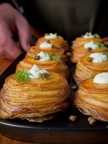 A close-up of Lemon–Dill Potato Stacks with Greek Yogurt & Capers.