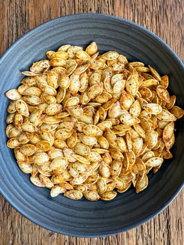 A bowl of Spicy Roasted Pumpkin Seeds with Paprika, Cayenne & Garlic.