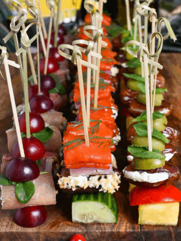 Rows of festive skewer appetizers with dates.