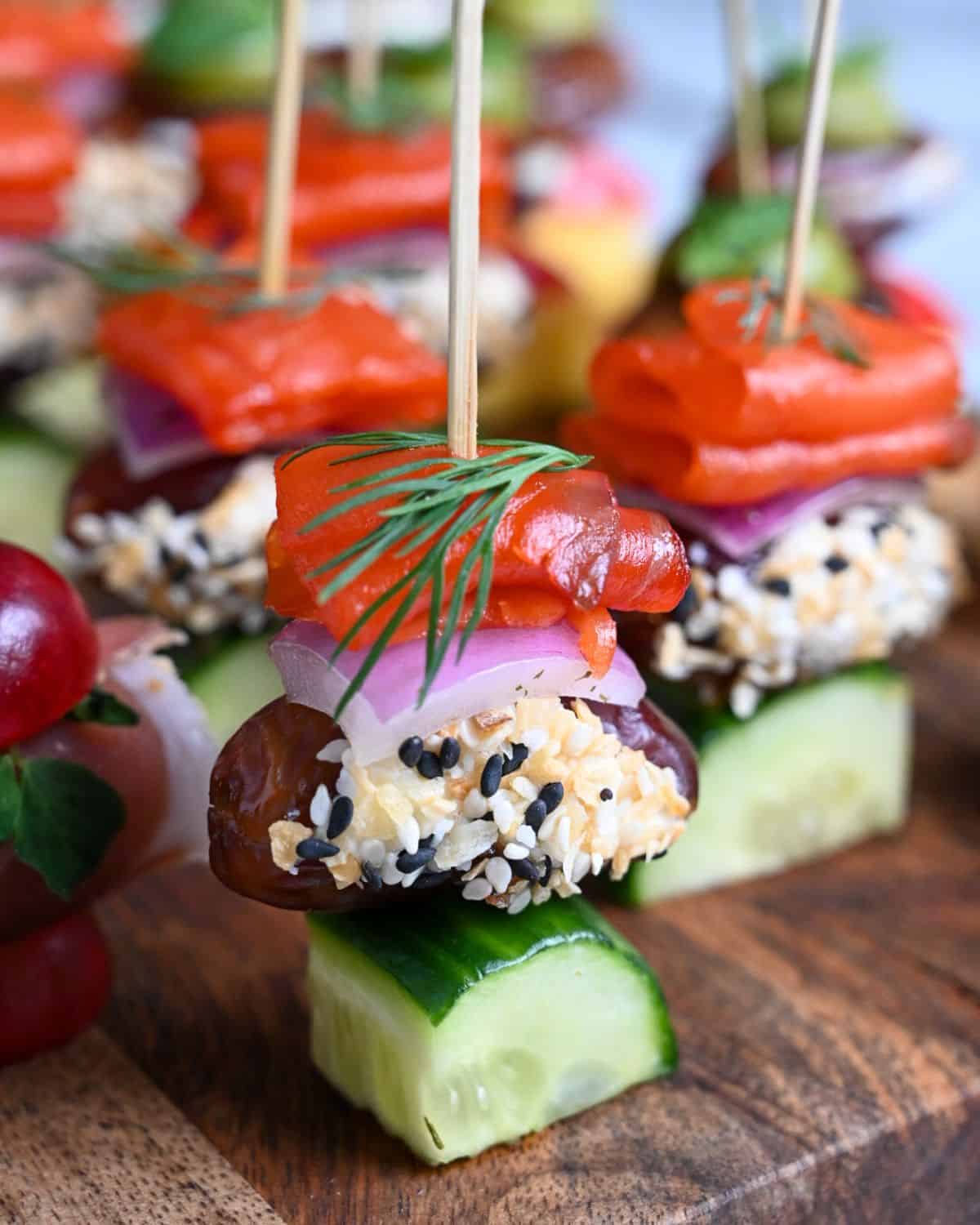 A close-up of Everything Bagel, Salmon, Cream Cheese & Date Skewers.