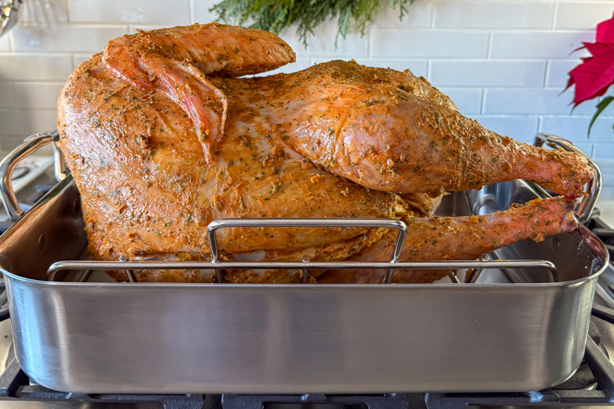 Place the turkey on its side in the roaster.