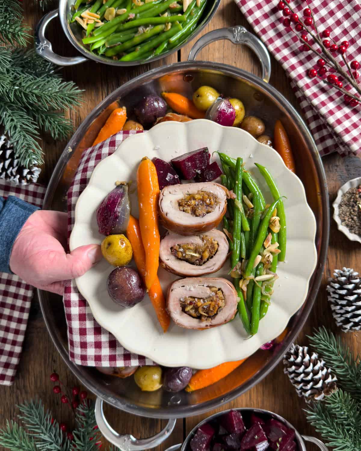 Wrapped pork tenderloin sliced into medallions and served with vegetables.