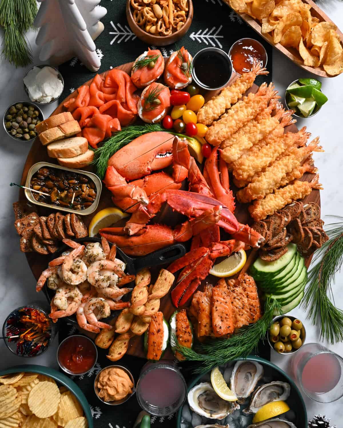 A SeaCuterie Board (Seafood Charcuterie Board) with a variety of seafood, sauces, crackers and dips.