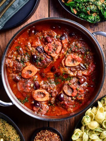 A pot of braised veal osso buco with Puttanesca sauce and served with orecchiette, garlicky rapini and lemon-parsley breadcrumbs.