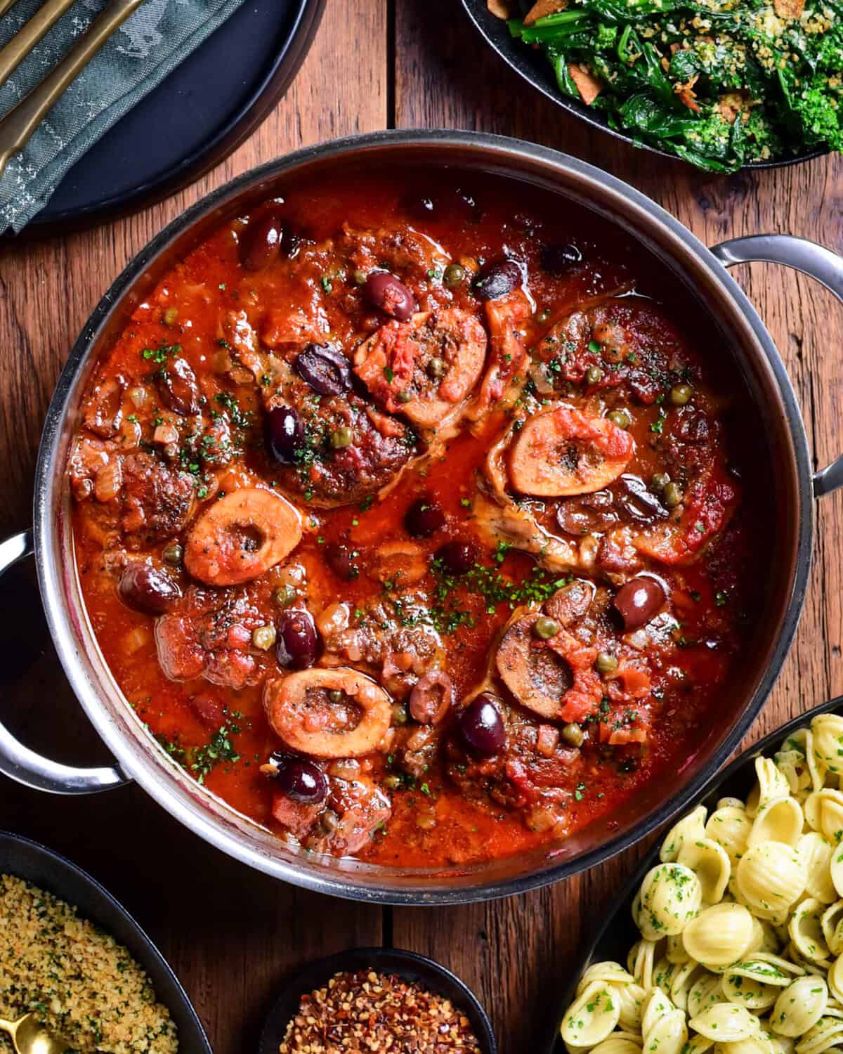 A pot of braised veal osso buco with Puttanesca sauce and served with orecchiette, garlicky rapini and lemon-parsley breadcrumbs.