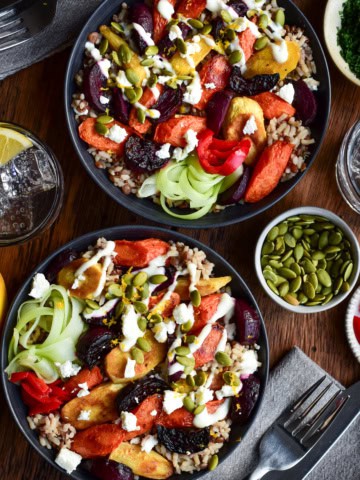 Two Winter Root Vegetable Bowls topped with Lemon Yogurt Dressing and pepitas.