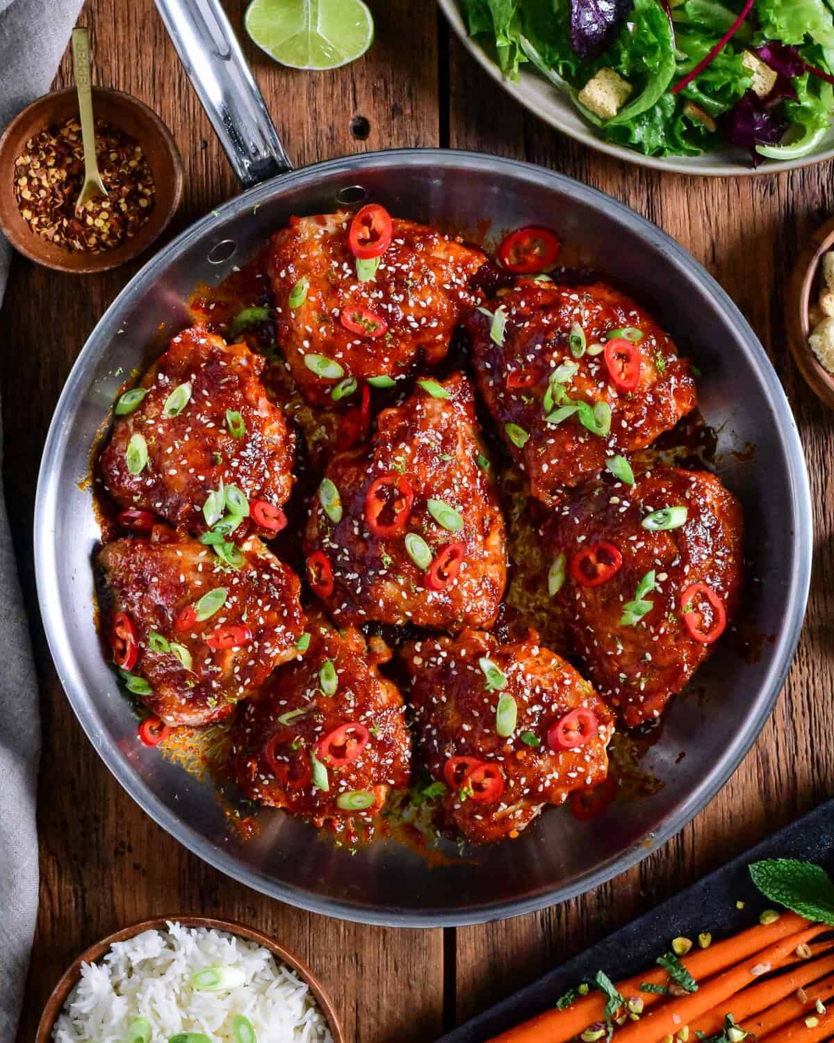 A skillet of crispy maple gochujang fire chicken thighs.