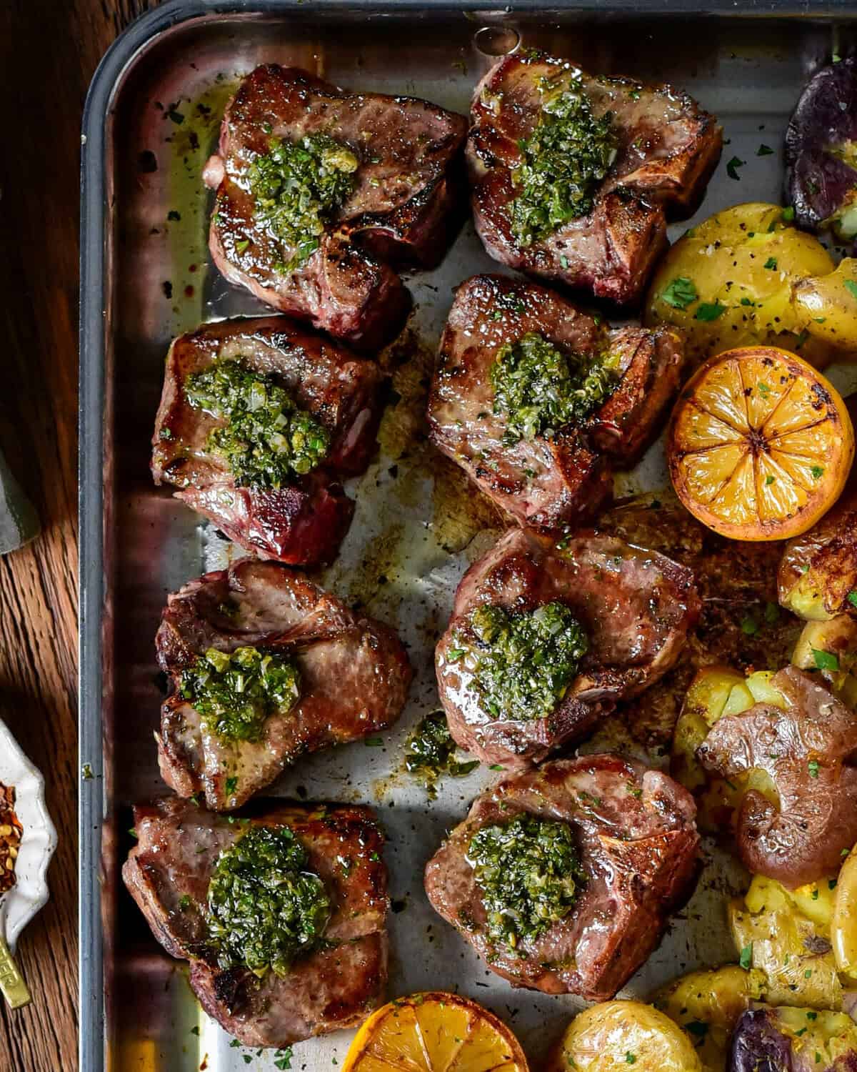 Garlic and anchovy lamb loin chops with warm salsa verde served with smashed baby potatoes. .