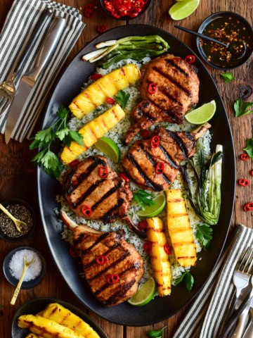 Chili-Lime Pork Chops with Grilled Pineapple served family-style over herb-lime jasmine rice.
