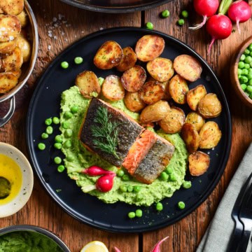 A dish served with Crispy Skin Salmon with Minty Pea Purée & Roasted Potatoes.