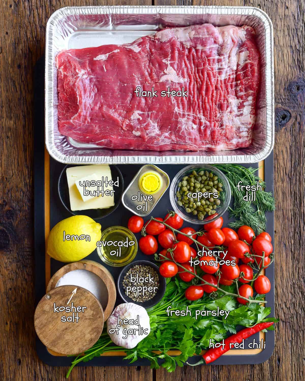 Ingredients for a grilled flank steak with roasted garlic lemon butter and roasted tomatoes.