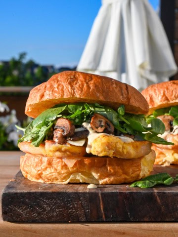 A Steakhouse Peameal Bacon Sandwich with Mushrooms, garlic aioli and greens.