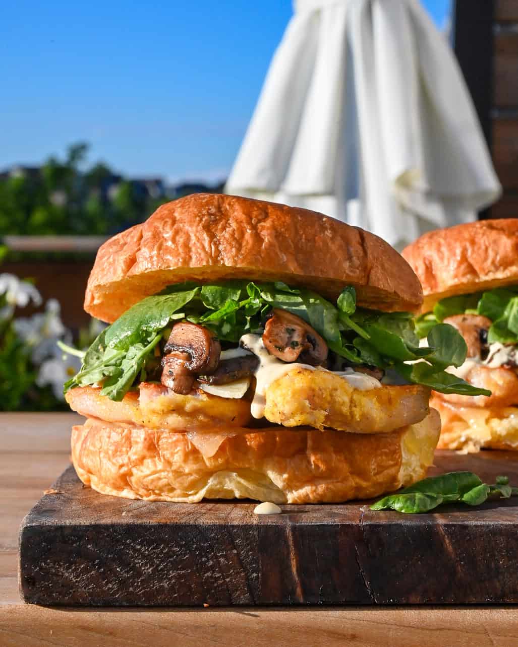 A Steakhouse Peameal Bacon Sandwich with Mushrooms, garlic aioli and greens. 